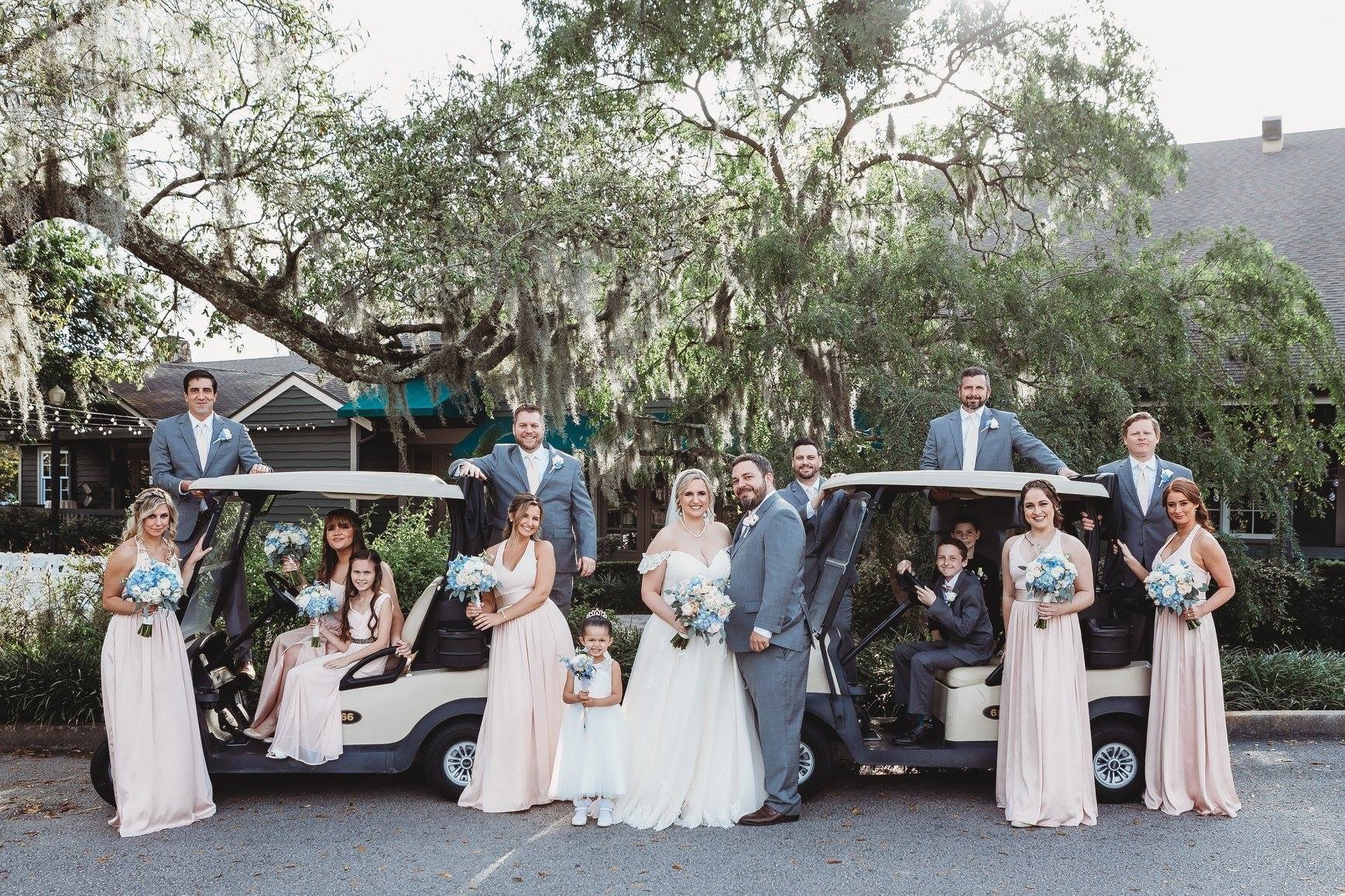wedding party posing with golf carts