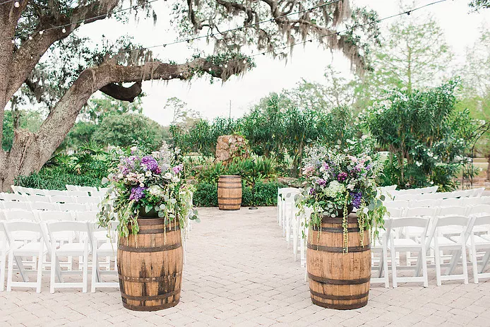 wine barrels framing the beginning of wedding walkway