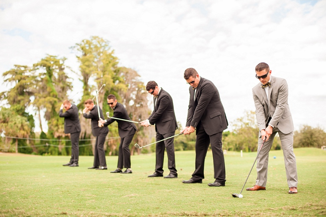 groom and groomsmen posing with golf clubs