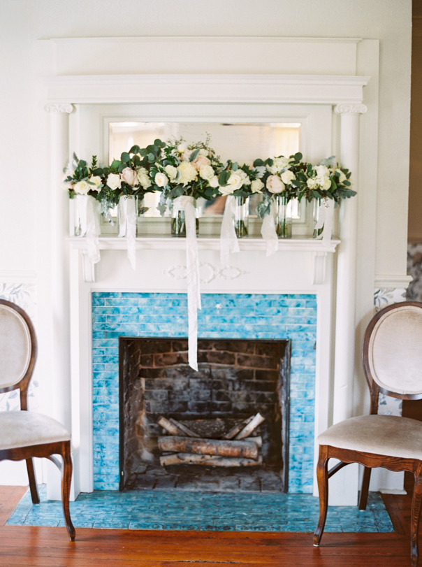 wedding decor on mantel above fireplace