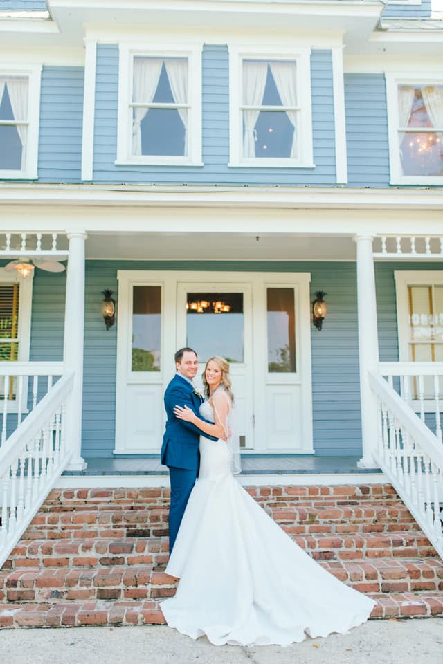newlywed couple poses on stairs of highland manor
